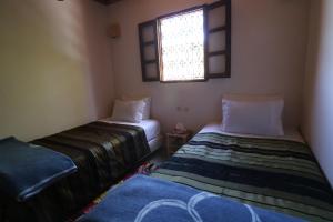 Postel nebo postele na pokoji v ubytování Gîte Imsker Elbour