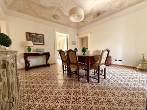 a dining room with a table and chairs at Casa Camille in Sorrento in Piano di Sorrento +20 photos