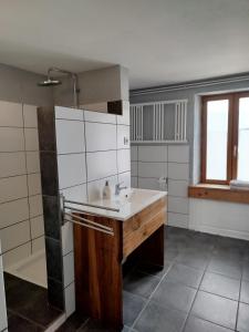 a large kitchen with a sink and a window at Appartement 1 à 4 pers in Granges-Aumontzey