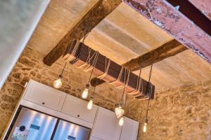 a wooden ceiling with lights hanging from it at Gudja 2BR - A Home of Character in the Village Core in Gudja +51 photos
