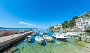a group of boats docked in a harbor at Serenity Apartments in Pisak