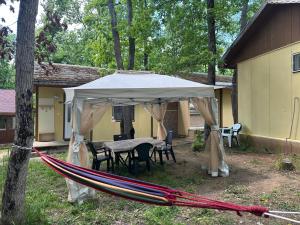 a tent with a table and chairs under it at Бунгала Мишел in Varna City +4 photos