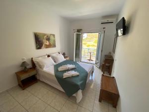 a bedroom with a bed with two folded towels on it at Athena Kythera in Dhiakofti