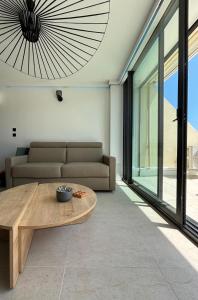 a living room with a couch and a table at Duchesse Luxe Cap - Naturiste in Cap d'Agde