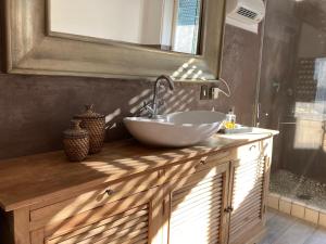 a bathroom with a bowl sink on a wooden counter at Casa Anna Capri Charme in Capri +27 photos