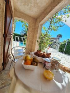 a table with a bowl of fruit on a table at Appartement Rez de Villa Terrasse Piscine Parking privé in Hyères