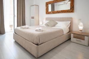 a bedroom with a bed with two towels on it at Catania Over Time - Tourist Rooms in Catania