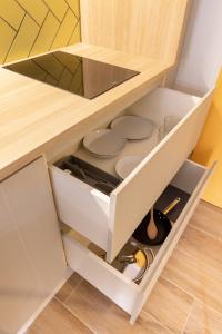 a drawer in a kitchen with plates and scissors at E4 - Estudio La Orotava in La Orotava