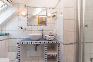 a bathroom with a sink and a mirror at Hotel Villa Sonneck-Adults Only in Sankt Peter-Ording +77 photos