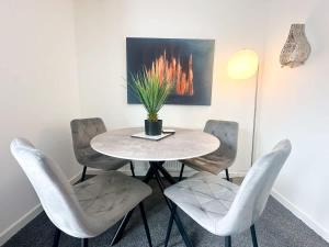 a dining room with a table and four chairs at Aristotle House by Blue Skies Stays in Stockton-on-Tees