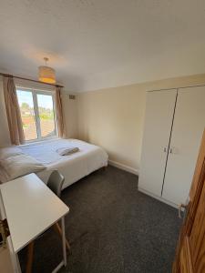 a small bedroom with a bed and a window at 3-bed house with parking in CB1 in CBG