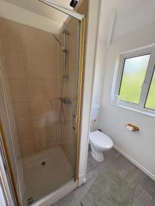 a bathroom with a shower and a toilet at 3-bed house with parking in CB1 in CBG