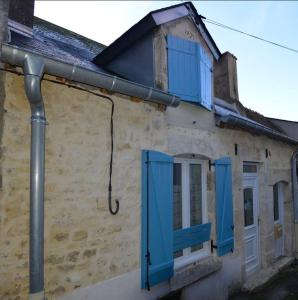 an old building with blue shutters on it at Butterfly Cottage in Pouilly-sur-Loire