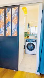 a door leading into a kitchen with a washing machine at Levalet BNB - La Défense Courbevoie in Courbevoie +11 photos