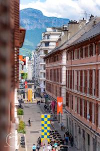a view of a city street with buildings and people at Les Arcades WiFi Historic Center in Chambéry +18 photos