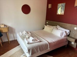 a bedroom with a bed with towels on it at Hôtel Le Boïate in Arès