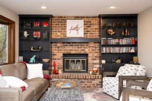 a living room with a couch and a fireplace at Creekside Lodge in Minnetonka