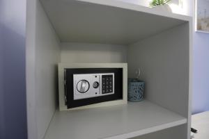 a microwave in a niche in a wall at Don Peppe Rooms With Beach Service Included in Tropea