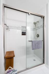 a shower with a glass door in a bathroom at Creekside Lodge in Minnetonka