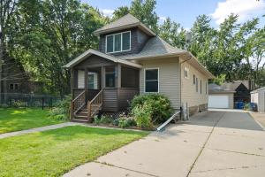 a house with a porch and a driveway at Cherokee Park Family Escape in Saint Paul