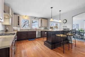a kitchen with a island in the middle of a room at Minnetonka Dream in Orono