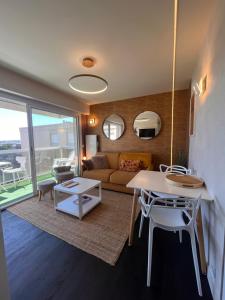 a living room with a table and a couch at Le Cézembre, au pied de la plage in Saint Malo