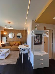 a living room with a couch and a table at Le Cézembre, au pied de la plage in Saint Malo