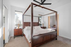 a bedroom with a canopy bed with a ceiling fan at The Happy Home in Lakeland