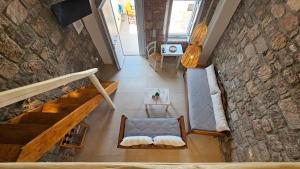 an overhead view of a living room with a stone wall at Efi's Apartments in Plaka Milou