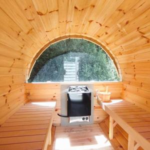 an inside of a wooden cabin with a stove in it at ZEcamping 3 étoiles animaux acceptés piscine chauffée restaurant et soirées in Huelgoat