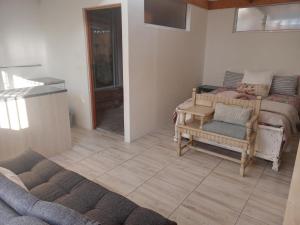 a living room with two beds and a couch at Klagesoek in Vosburg