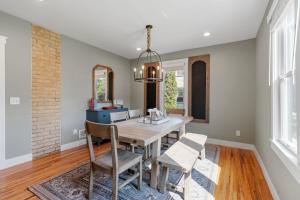 a dining room with a table and chairs and a mirror at Chaska Charmer in Chaska