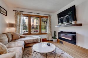 a living room with a couch and a fireplace at Grand Residence in Saint Paul