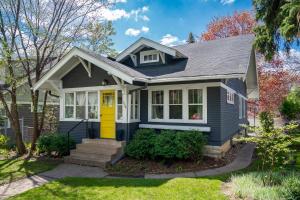 a blue house with a yellow door at Grand Residence in Saint Paul