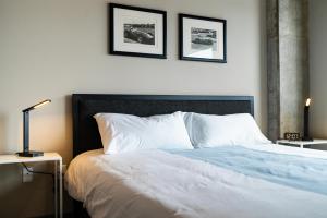a bedroom with a bed with two pictures on the wall at Sable 602 - Alcove in Minneapolis +27 photos