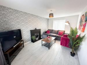 a living room with a couch and a fireplace at Ayresome House By Blue Skies Stays in Middlesbrough