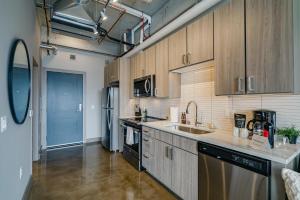 a kitchen with wooden cabinets and a sink at Sable 801 - Alcove in Minneapolis