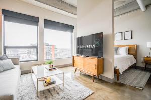 a living room with a bed and a tv at Sable 801 - Alcove in Minneapolis