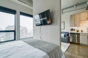 a bedroom with a bed and a tv on a wall at Sable 802 - Alcove in Minneapolis