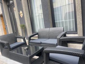 a pair of chairs and a table on a patio at Liams Cozy Villa in Korçë