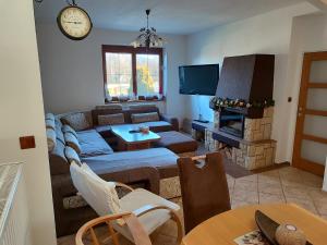 a living room with a couch and a fireplace at Chalupa s výhledem na Radhošť in Frenštát pod Radhoštěm