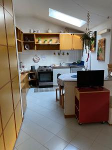 a kitchen with a table and a stove top oven at La mansarda di Orni in Ivrea