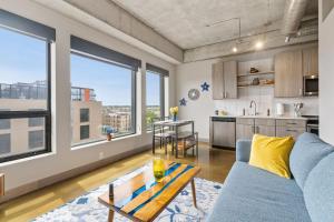 a living room with a blue couch and a table at Sable 604 - One Bedroom in Minneapolis