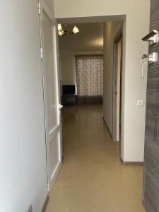 a hallway with a door leading to a living room at Дом для отдыха in Yerevan +3 photos