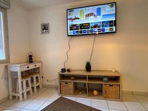 a living room with a flat screen tv on the wall at La Belle Garde in Toulouse