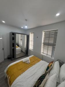 a bedroom with a large bed with a large mirror at F4 Luxury Stays One bed apartment with Parking in Ilford