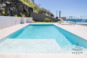 a swimming pool in the backyard of a house at Villa Nicuma by ESCAPE to Madeira in Calheta