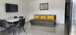 a living room with a couch and a table and yellow pillows at Villa Dian in Neum