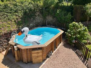 a pool with a rubber duck and a swan in it at Auberge de La Chaloire in La Petite-Verrière