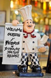 a statue of a chef holding a sign at Boracay Holiday Resort in Boracay